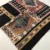 Details of the finishes and fluid drape of the FT25 Luxury collection scarf against a neutral background